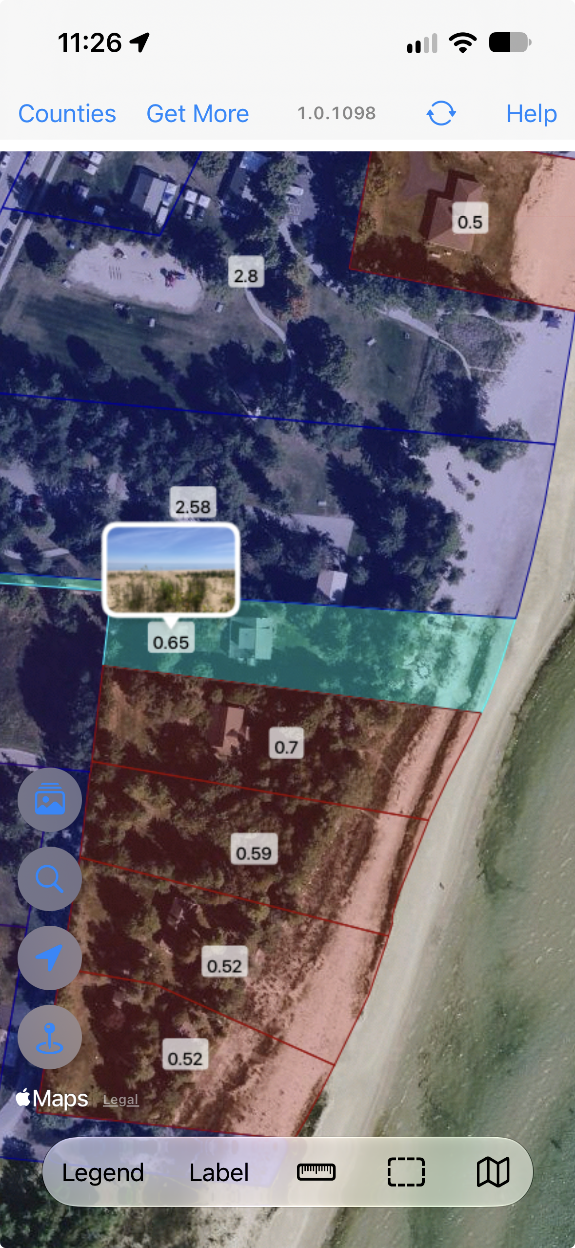 WI 2026 aerial parcel map with a selected parcel in turquoise and a beach photo thumbnail above it; the photos button is visible on the left